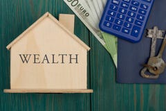 Λίγο σπίτι με το κείμενο & x22 Wealth& x22 , κλειδιά, υπολογιστής, διαβατήριο, χρήματα στοκ φωτογραφία με δικαίωμα ελεύθερης χρήσης Λίγο σπίτι με το κείμενο & x22 Wealth& x22 , κλειδιά, υπολογιστής, διαβατήριο, χρήματα στοκ φωτογραφία με δικαίωμα ελεύθερης χρήσης