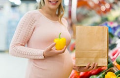 Λαχανικά αγοράς εγκύων γυναικών στο μανάβικο στοκ εικόνα Λαχανικά αγοράς εγκύων γυναικών στο μανάβικο στοκ εικόνα