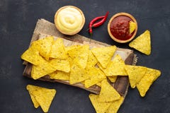 Μεξικάνικα nachos τσιπ καλαμποκιού με τις σάλτσες στο σκοτεινό υπόβαθρο στοκ φωτογραφία με δικαίωμα ελεύθερης χρήσης Μεξικάνικα nachos τσιπ καλαμποκιού με τις σάλτσες στο σκοτεινό υπόβαθρο στοκ φωτογραφία με δικαίωμα ελεύθερης χρήσης