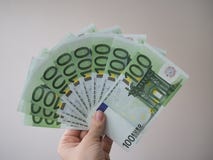 Μια γυναίκα κρατά στο χέρι της πολλά τραπεζογραμμάτια στις μετονομασίες του ανεμιστήρα 100 ευρώ στοκ εικόνα με δικαίωμα ελεύθερης χρήσης Μια γυναίκα κρατά στο χέρι της πολλά τραπεζογραμμάτια στις μετονομασίες του ανεμιστήρα 100 ευρώ στοκ εικόνα με δικαίωμα ελεύθερης χρήσης