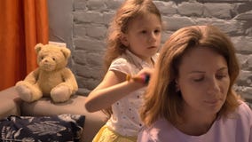 Μικρό κορίτσι που βουρτσίζει την τρίχα μητέρων της ` s με τη βούρτσα γηα τα μαλλιά, σύγχρονο υπόβαθρο καθιστικών, οικογενειακή έν φιλμ μικρού μήκους Μικρό κορίτσι που βουρτσίζει την τρίχα μητέρων της ` s με τη βούρτσα γηα τα μαλλιά, σύγχρονο υπόβαθρο καθιστικών, οικογενειακή έν φιλμ μικρού μήκους
