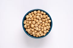 Μπλε κύπελλο με ξηρά chickpeas στο άσπρο υπόβαθρο στοκ εικόνες Μπλε κύπελλο με ξηρά chickpeas στο άσπρο υπόβαθρο στοκ εικόνες