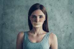Νέα λυπημένη γυναίκα με το δεμένο με ταινία στόμα με τα τρόφιμα του Word στοκ εικόνες Νέα λυπημένη γυναίκα με το δεμένο με ταινία στόμα με τα τρόφιμα του Word στοκ εικόνες