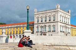 Νέοι που κάθονται στη σκάλα που οδηγεί στον ποταμό Tagus στο τετράγωνο εμπορίου στοκ φωτογραφία Νέοι που κάθονται στη σκάλα που οδηγεί στον ποταμό Tagus στο τετράγωνο εμπορίου στοκ φωτογραφία