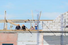 Οι οικοδόμοι εργαζομένων κάνουν την εγκατάσταση των υλικών σκαλωσιάς στοκ φωτογραφία με δικαίωμα ελεύθερης χρήσης Οι οικοδόμοι εργαζομένων κάνουν την εγκατάσταση των υλικών σκαλωσιάς στοκ φωτογραφία με δικαίωμα ελεύθερης χρήσης