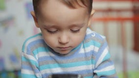 Παιχνίδι μικρών παιδιών με μια συσκευή smartphone φιλμ μικρού μήκους Παιχνίδι μικρών παιδιών με μια συσκευή smartphone φιλμ μικρού μήκους