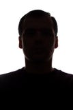 Πορτρέτο ενός νεαρού άνδρα, μπροστινή άποψη - το σκοτάδι απομόνωσε τη σκιαγραφία στοκ φωτογραφία Πορτρέτο ενός νεαρού άνδρα, μπροστινή άποψη - το σκοτάδι απομόνωσε τη σκιαγραφία στοκ φωτογραφία