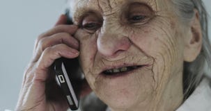 Πρόσωπο κινηματογραφήσεων σε πρώτο πλάνο μιας γιαγιάς με τις βαθιές ρυτίδες που μιλούν σε ένα κινητό τηλέφωνο απόθεμα βίντεο Πρόσωπο κινηματογραφήσεων σε πρώτο πλάνο μιας γιαγιάς με τις βαθιές ρυτίδες που μιλούν σε ένα κινητό τηλέφωνο απόθεμα βίντεο