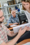 Σκηνή τρία γραφείων εργαζόμενοι Στοκ Εικόνες Σκηνή τρία γραφείων εργαζόμενοι Στοκ Εικόνες