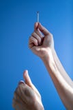 Σπασμένο ραβδί αντιστοιχιών χεριών γυναικών εκμετάλλευση στο μπλε κλίμα στοκ εικόνες Σπασμένο ραβδί αντιστοιχιών χεριών γυναικών εκμετάλλευση στο μπλε κλίμα στοκ εικόνες