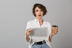 Συγκλονισμένη νέα τοποθέτηση επιχειρησιακών γυναικών που απομονώνεται πέρα από τον γκρίζο καφέ κατανάλωσης εφημερίδων ανάγνωσης υ στοκ εικόνες με δικαίωμα ελεύθερης χρήσης Συγκλονισμένη νέα τοποθέτηση επιχειρησιακών γυναικών που απομονώνεται πέρα από τον γκρίζο καφέ κατανάλωσης εφημερίδων ανάγνωσης υ στοκ εικόνες με δικαίωμα ελεύθερης χρήσης