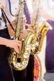 Τα κορίτσια παίζουν saxophones τη σαφή ηλιόλουστη ημέρα στην οδό Εορταστικός ομο στοκ εικόνα Τα κορίτσια παίζουν saxophones τη σαφή ηλιόλουστη ημέρα στην οδό Εορταστικός ομο στοκ εικόνα