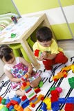 Τα προσχολικά παιδιά χτίζουν τα κάστρα με τους πλαστικούς κύβους στοκ εικόνες με δικαίωμα ελεύθερης χρήσης Τα προσχολικά παιδιά χτίζουν τα κάστρα με τους πλαστικούς κύβους στοκ εικόνες με δικαίωμα ελεύθερης χρήσης