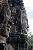 Τα πρόσωπα χάρασαν στην πέτρα στο Bayon Wat στο αργά το απόγευμα φως του ήλιου, ένας 12ος ναός αιώνα μέσα στο Angkor στοκ φωτογραφία με δικαίωμα ελεύθερης χρήσης Τα πρόσωπα χάρασαν στην πέτρα στο Bayon Wat στο αργά το απόγευμα φως του ήλιου, ένας 12ος ναός αιώνα μέσα στο Angkor στοκ φωτογραφία με δικαίωμα ελεύθερης χρήσης