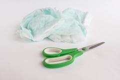 Τεμαχισμένα pampers παιδιών και ψαλίδι σε ένα άσπρο υπόβαθρο, πάνες στοκ εικόνες Τεμαχισμένα pampers παιδιών και ψαλίδι σε ένα άσπρο υπόβαθρο, πάνες στοκ εικόνες
