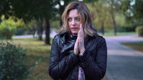 Το κορίτσι επάγωσε στο πάρκο φθινοπώρου η νέα γυναίκα τύλιξε σε ένα μαντίλι και αναπνέει σε ετοιμότητα του για να τους θερμάνει ε φιλμ μικρού μήκους Το κορίτσι επάγωσε στο πάρκο φθινοπώρου η νέα γυναίκα τύλιξε σε ένα μαντίλι και αναπνέει σε ετοιμότητα του για να τους θερμάνει ε φιλμ μικρού μήκους
