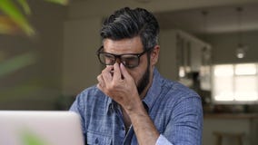 Τονισμένο Μεσο-Ανατολικό άτομο που εργάζεται στον υπολογιστή Τονισμένο Μεσο-Ανατολικό άτομο που εργάζεται στον υπολογιστή