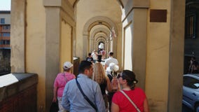 Φλωρεντία, Ιταλία, τον Ιούνιο του 2017: Μια μεγάλη ομάδα τουριστών με έναν οδηγό πηγαίνει κατά μήκος της διάσημης γέφυρας πέρα απ φιλμ μικρού μήκους Φλωρεντία, Ιταλία, τον Ιούνιο του 2017: Μια μεγάλη ομάδα τουριστών με έναν οδηγό πηγαίνει κατά μήκος της διάσημης γέφυρας πέρα απ φιλμ μικρού μήκους