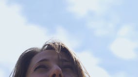 Χαμογελώντας το όμορφο τηγάνι γυναικών στο μπλε ουρανό, θηλυκό brunette που απολαμβάνει τη ζωή χαρωπά φιλμ μικρού μήκους Χαμογελώντας το όμορφο τηγάνι γυναικών στο μπλε ουρανό, θηλυκό brunette που απολαμβάνει τη ζωή χαρωπά φιλμ μικρού μήκους