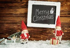 Χαριτωμένες κούκλες λίγου Santa με τη Χαρούμενα Χριστούγεννα στοκ φωτογραφία με δικαίωμα ελεύθερης χρήσης Χαριτωμένες κούκλες λίγου Santa με τη Χαρούμενα Χριστούγεννα στοκ φωτογραφία με δικαίωμα ελεύθερης χρήσης