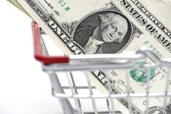Χρήματα δολαρίων με το κάρρο αγορών στο άσπρο υπόβαθρο που πυροβολείται στο στήριγμα στοκ φωτογραφία Χρήματα δολαρίων με το κάρρο αγορών στο άσπρο υπόβαθρο που πυροβολείται στο στήριγμα στοκ φωτογραφία