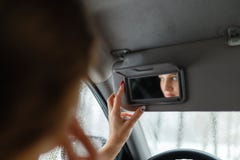 Όμορφα ξανθά βλέμματα σε έναν καθρέφτη αυτοκινήτων στοκ φωτογραφία Όμορφα ξανθά βλέμματα σε έναν καθρέφτη αυτοκινήτων στοκ φωτογραφία