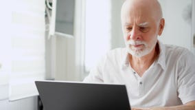 Όμορφο ηλικιωμένο ανώτερο άτομο που εργάζεται στο φορητό προσωπικό υπολογιστή στο σπίτι Μακρινή ανεξάρτητη εργασία για την αποχώρ απόθεμα βίντεο Όμορφο ηλικιωμένο ανώτερο άτομο που εργάζεται στο φορητό προσωπικό υπολογιστή στο σπίτι Μακρινή ανεξάρτητη εργασία για την αποχώρ απόθεμα βίντεο