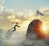 Бизнесмен скача на весну для достижения флага Цель бизнеса достижения и трудная концепция карьеры стоковые фотографии rf Бизнесмен скача на весну для достижения флага Цель бизнеса достижения и трудная концепция карьеры стоковые фотографии rf