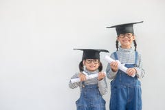 image photo : Siblings children girl graduation with cap and diploma over white