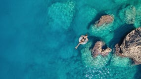 Вид с воздуха на девушке на поверхности моря стоковые изображения rf Вид с воздуха на девушке на поверхности моря стоковые изображения rf