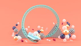 Голубые русские горки среди красочных шариков на розовой предпосылке стоковые изображения Голубые русские горки среди красочных шариков на розовой предпосылке стоковые изображения