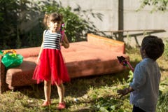 Группа в составе счастливые дети играя outdoors сад потехи имея малышей стоковое изображение rf Группа в составе счастливые дети играя outdoors сад потехи имея малышей стоковое изображение rf