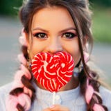 Девушка с леденцом на палочке Женщина модели очарования красоты с конфетой леденца на палочке ультрамодного пинка удерживания вол стоковое фото Девушка с леденцом на палочке Женщина модели очарования красоты с конфетой леденца на палочке ультрамодного пинка удерживания вол стоковое фото