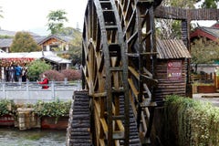 Деревянное колесо водяной мельницы в квадрате древнего города Lijiang, Юньнань, Китая стоковая фотография rf Деревянное колесо водяной мельницы в квадрате древнего города Lijiang, Юньнань, Китая стоковая фотография rf