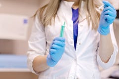 Доктор подготавливает дать впрыску Доктор, женская медсестра или anesthetist с хирургической иглой стоковое изображение Доктор подготавливает дать впрыску Доктор, женская медсестра или anesthetist с хирургической иглой стоковое изображение