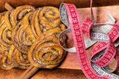 домодельные сладостные крены циннамона на красной плите с ручками cinnamons и рулетки пустыни Стоковая Фотография RF домодельные сладостные крены циннамона на красной плите с ручками cinnamons и рулетки пустыни Стоковая Фотография RF
