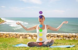 Женщина делая йогу в представлении лотоса с 7 chakras стоковое фото Женщина делая йогу в представлении лотоса с 7 chakras стоковое фото
