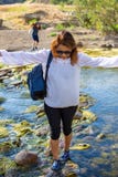 Женщина пересекая поток с дочерью играя в потоке или реке стоковые фото Женщина пересекая поток с дочерью играя в потоке или реке стоковые фото