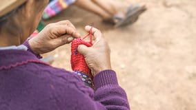 Закройте вверх соткать в Перу Cusco, женщина Перу одетая в красочном традиционном родном перуанском заключении вязать ковер с стоковые фотографии rf Закройте вверх соткать в Перу Cusco, женщина Перу одетая в красочном традиционном родном перуанском заключении вязать ковер с стоковые фотографии rf