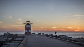 Заход солнца на пляже Гааге scheveningen маяка стоковая фотография rf Заход солнца на пляже Гааге scheveningen маяка стоковая фотография rf