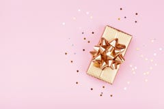 Золотой подарок или присутствующий confetti коробки и звезд на розовом взгляде столешницы Плоский состав положения для дня рожден стоковое фото rf Золотой подарок или присутствующий confetti коробки и звезд на розовом взгляде столешницы Плоский состав положения для дня рожден стоковое фото rf