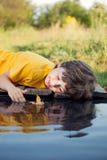 Игра мальчика с кораблем лист осени в воде, детях в парке играет w стоковые фото Игра мальчика с кораблем лист осени в воде, детях в парке играет w стоковые фото
