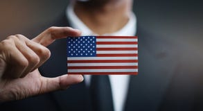 Карта удерживания бизнесмена флага Соединенных Штатов Америки стоковые изображения Карта удерживания бизнесмена флага Соединенных Штатов Америки стоковые изображения
