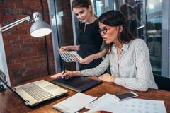 Команда женского дизайнера по интерьеру рисуя новый проект используя графическую таблетку, компьтер-книжку и цветовую палитру сид стоковые фото Команда женского дизайнера по интерьеру рисуя новый проект используя графическую таблетку, компьтер-книжку и цветовую палитру сид стоковые фото