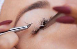Конец процедуры удаления ресницы вверх Красивая женщина с длинными плетками в салоне красоты стоковое фото rf Конец процедуры удаления ресницы вверх Красивая женщина с длинными плетками в салоне красоты стоковое фото rf