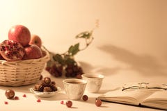 Корзина плода, даты на серебряном шаре, аравийские чашки чая с открытой книгой и стекла чтения стоковое фото rf Корзина плода, даты на серебряном шаре, аравийские чашки чая с открытой книгой и стекла чтения стоковое фото rf