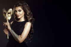 Красивая татуированная дама держа венецианскую маску в ее руке с жестом безмолвия стоковое изображение Красивая татуированная дама держа венецианскую маску в ее руке с жестом безмолвия стоковое изображение