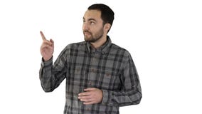 Красивый молодой человек идя и смотря к камере и указывая на стороны показывая что-то на белой предпосылке стоковое фото Красивый молодой человек идя и смотря к камере и указывая на стороны показывая что-то на белой предпосылке стоковое фото