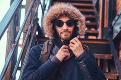 Красивый стильный молодой человек сидя на лестницах снаружи стоковые фотографии rf Красивый стильный молодой человек сидя на лестницах снаружи стоковые фотографии rf