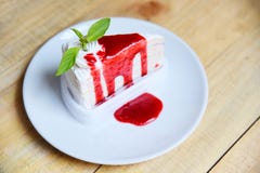 Кусок торта Crape с соусом клубники на белой плите на деревянных радугах куска пирога с взбитой сливк стоковое изображение rf Кусок торта Crape с соусом клубники на белой плите на деревянных радугах куска пирога с взбитой сливк стоковое изображение rf